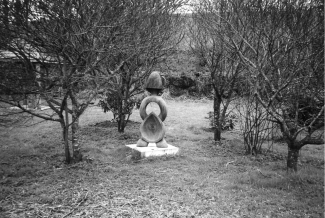 The Three Form Figure sculpture in its setting of alder buckthorn trees